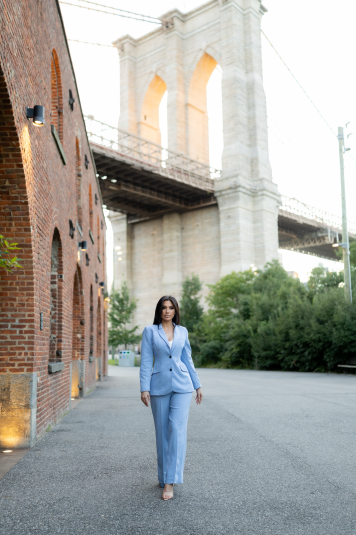 Person walking on a street with buildings in background